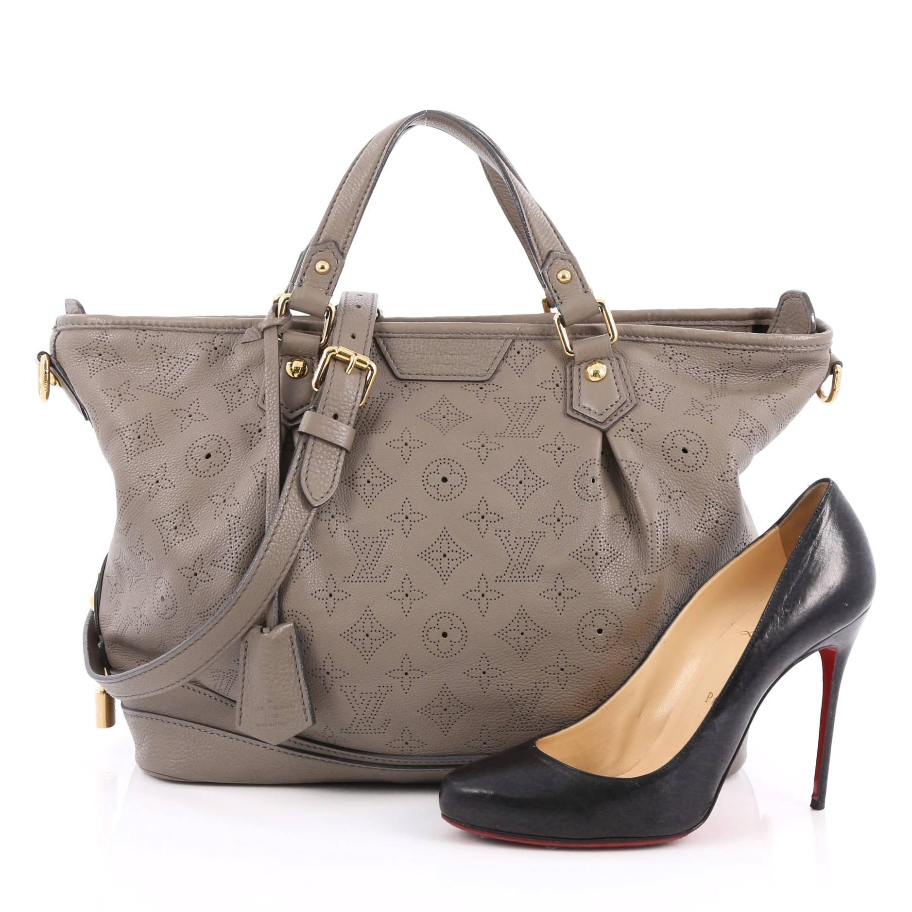 This authentic Louis Vuitton Stellar Handbag Mahina Leather PM displays understated simplicity and elegance with versatile functionality made for the modern woman. Crafted from taupe perforated mahina leather, this soft-structured tote features dual