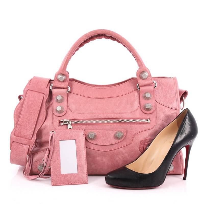 This authentic Balenciaga City Giant Studs Handbag Leather Medium is for the on-the-go fashionista. Constructed from pink leather, this popular bag features dual braided woven tall handles, exterior front zip pocket, iconic Balenciaga giant studs