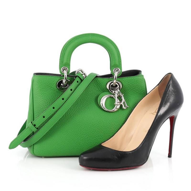 This authentic Christian Dior Diorissimo Tote Pebbled Leather Mini is an elegant, classic statement piece that every fashionista needs in her wardrobe. Crafted from green pebbled leather, this chic tote features smooth short dual handles with sleek