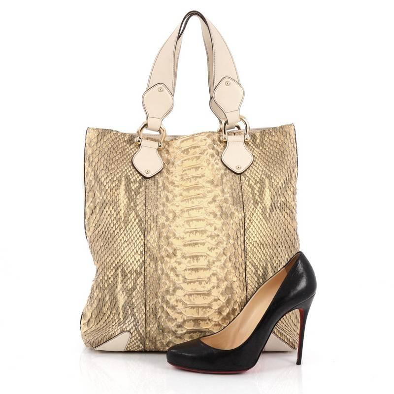 This authentic Gucci Creole Tote Python Large is a luxe tote that combines practicality and upscale fashion. Crafted from genuine metallic yellow and grey python skin, this chic bag features dual-flat top handles, cream leather trims, protective