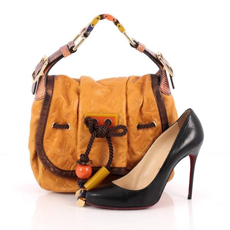 This authentic Louis Vuitton Kalahari Handbag Limited Edition Monogram Epices PM presented in the brand's Spring/Summer 2009 Collection aptly named after the beautiful sub-saharan African desert mixes traditional styling with luxurious ethnic motif.
