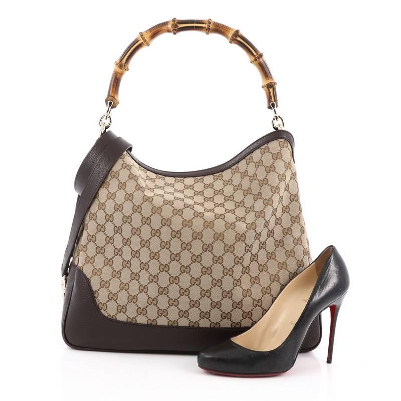 This authentic Gucci Diana Bamboo Shoulder Bag GG Canvas Medium is classic and sophisticated in design, perfect for casual looks. Crafted in brown GG canvas with black leather trims, this shoulder bag features Gucci's signature bamboo loop handle,