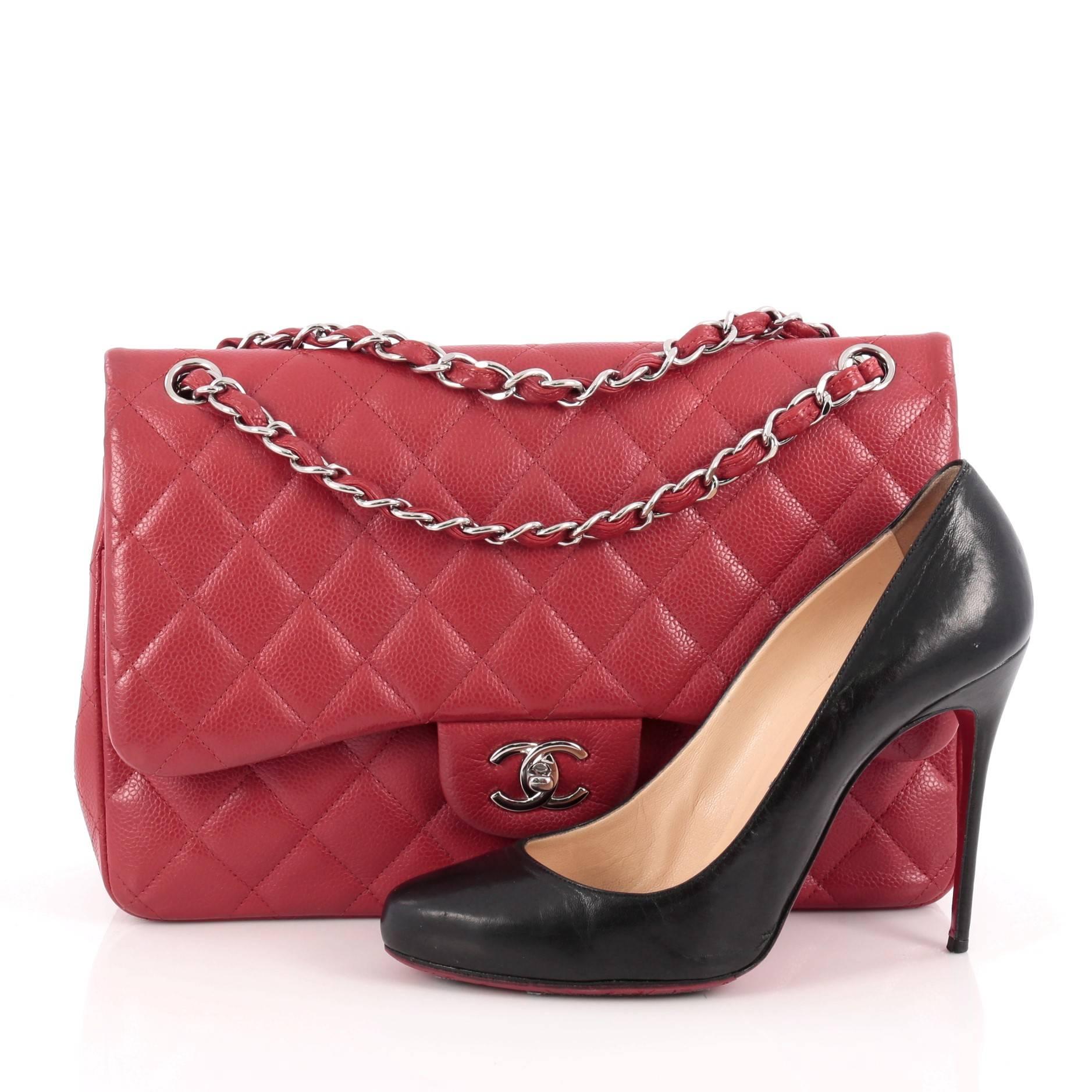 This authentic Chanel Classic Double Flap Bag Quilted Caviar Jumbo is one of the brand's most popular style. Crafted from red caviar leather, this elegant flap features Chanel's signature diamond quilted design, woven-in leather chain straps,