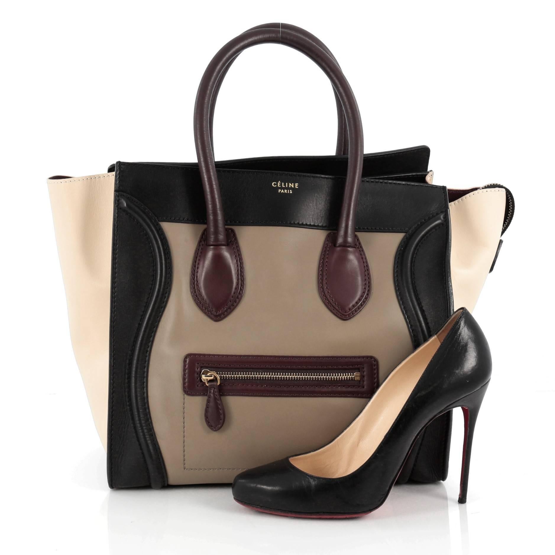 This authentic Celine Multicolor Luggage Handbag Leather Mini showcases an elegant day-to-day style essential for any fashionista. Constructed in beautiful taupe, black, maroon and off-white leather, this popular tote features a front zipper pocket,