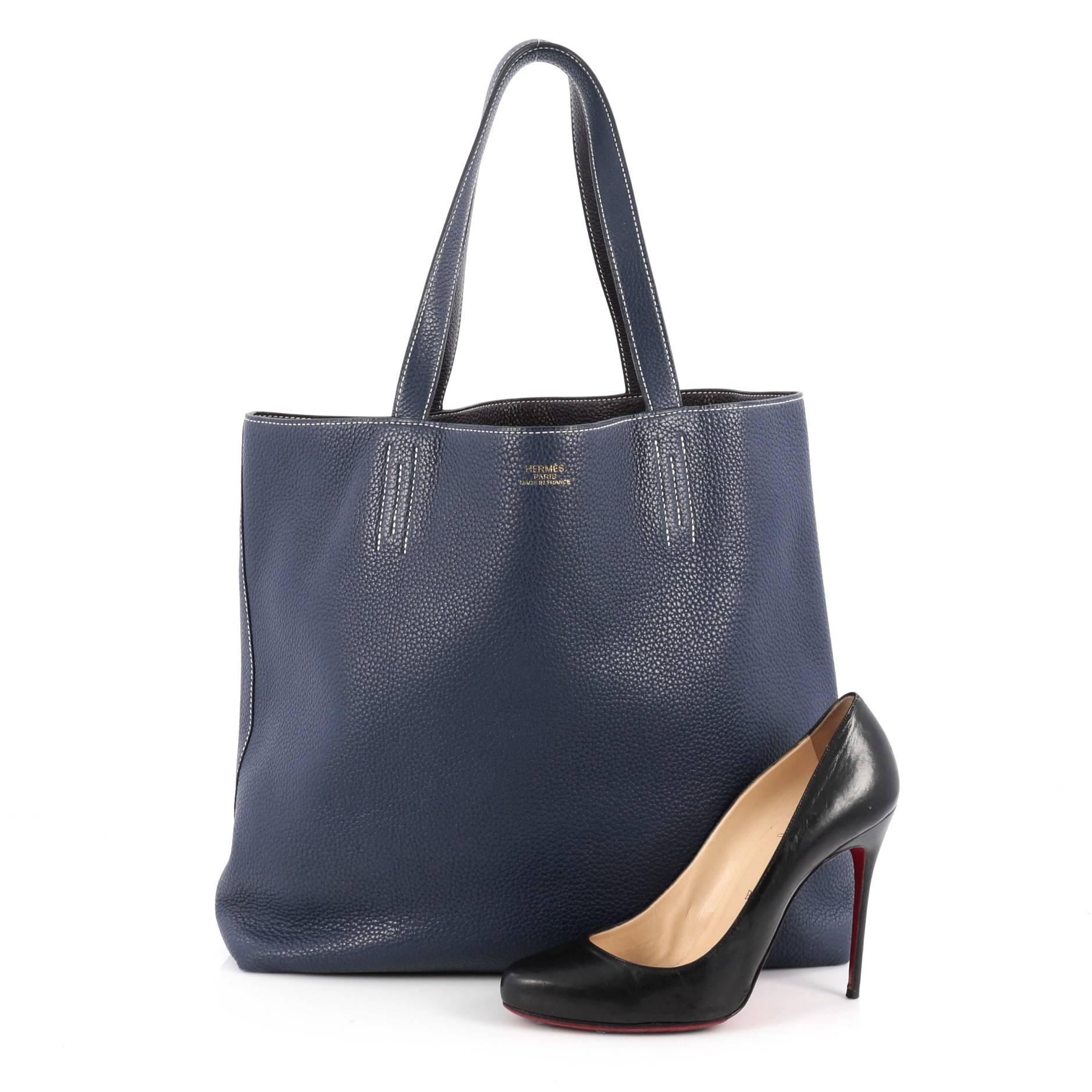 This authentic Hermes Double Sens Tote Clemence 45 combines a simple and functional style from Hermes perfect for everyday use. Crafted from soft luxurious reversible veau taurillon clemence leather in blue sapphire and raisin purple, this versatile