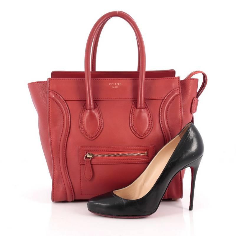 This authentic Celine Luggage Handbag Grainy Leather Micro is one of the most sought-after bags beloved by fashionistas. Crafted from red grainy leather, this minimalist tote features dual-rolled handles, an exterior front pocket, protective base