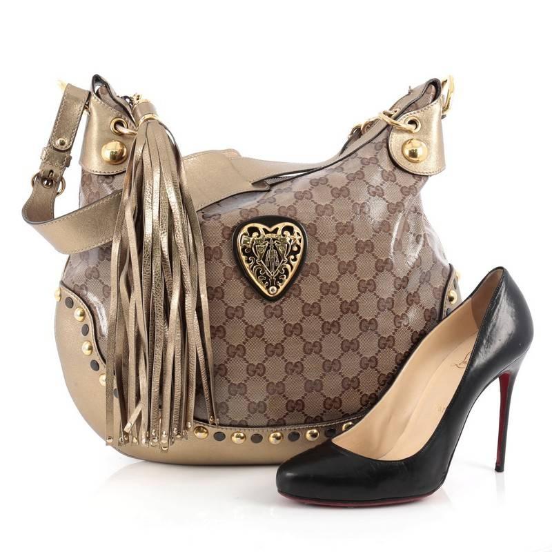 This authentic Gucci Babouska Heart Hobo GG Coated Canvas Large is sophisticated and luxurious in design ideal for everyday use. Crafted in brown GG coated canvas, this lovely bag features gold leather trims, adjustable shoulder strap, heart shaped