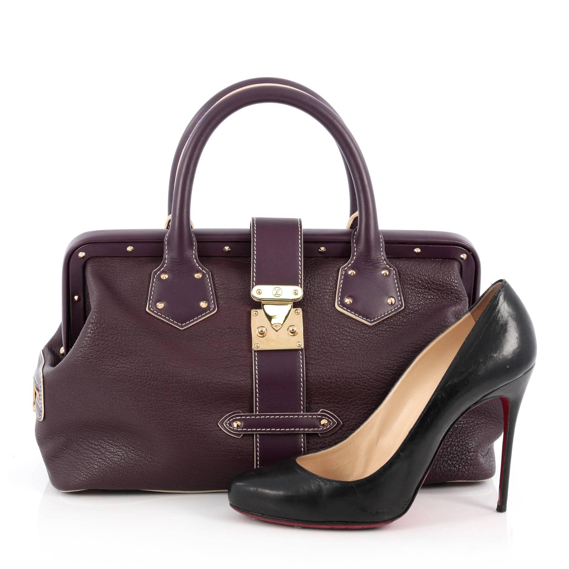 This authentic Louis Vuitton Suhali L'ingenieux Handbag Leather PM is a bright and glamorous satchel that adds a stylish touch to your look. Crafted from plum purple suhali goat leather, this doctor frame bag features, zipped side pockets,