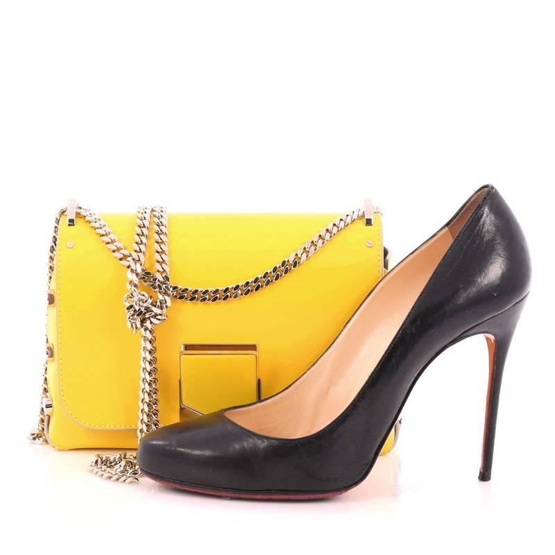 This authentic Jimmy Choo Lockett Chain Shoulder Bag Leather Petite is a luxurious, chic, accessory made for any fashionista. Crafted from yellow leather, this simple yet edgy crossbody features a gold-tone chain-link shoulder strap, polished gold
