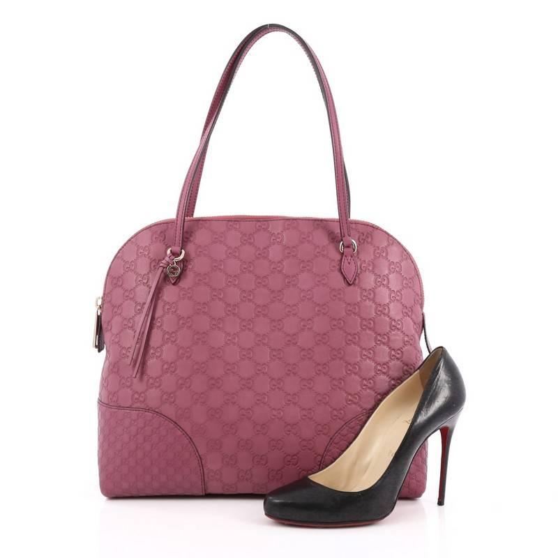 This authentic Gucci Bree Dome Tote Guccissima Leather Medium is perfect for everyday casual look. Crafted in dark pink guccissima leather, this dome-style tote features tall slim handles, small Gucci charm and gold-tone hardware accents. Its top