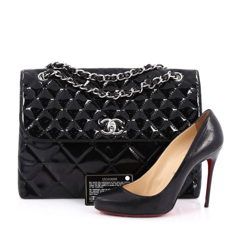 This authentic Chanel In The Business Flap Bag Quilted Patent Vinyl Maxi is a marvelous tote for day or evening looks. Crafted from glossy black patent vinyl, this timeless flap features dual woven-in vinyl chain straps, large shaped diamond quilted