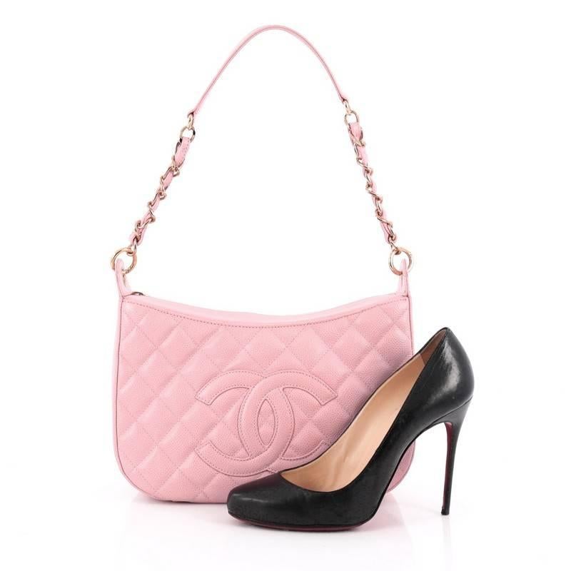 This authentic Chanel Timeless CC Chain Shoulder Bag Quilted Caviar Medium showcases a modern and stylized design with vintage-inspired flair. Crafted from light pink diamond quilted caviar leather, this feminine shoulder bag features woven-in