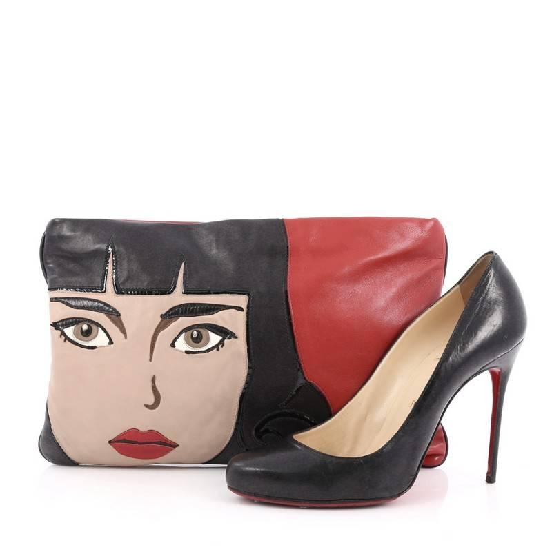 This authentic Prada 50's Graphic Clutch Nappa Leather presented in the brand's Spring-Summer 2014 Collection, inspired by the 50's American graphics, is a sweet and kitschy motif made for the warmer seasons. Crafted from red, beige and black nappa
