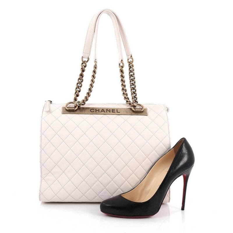 This authentic Chanel Rita Dome Bag Quilted Goatskin Large is from the brands' Cruise 2012 Collection. Crafted from off-white quilted goatskin, this chic and stylish bag features dual leather and chain top handles, aged bronze "CHANEL"