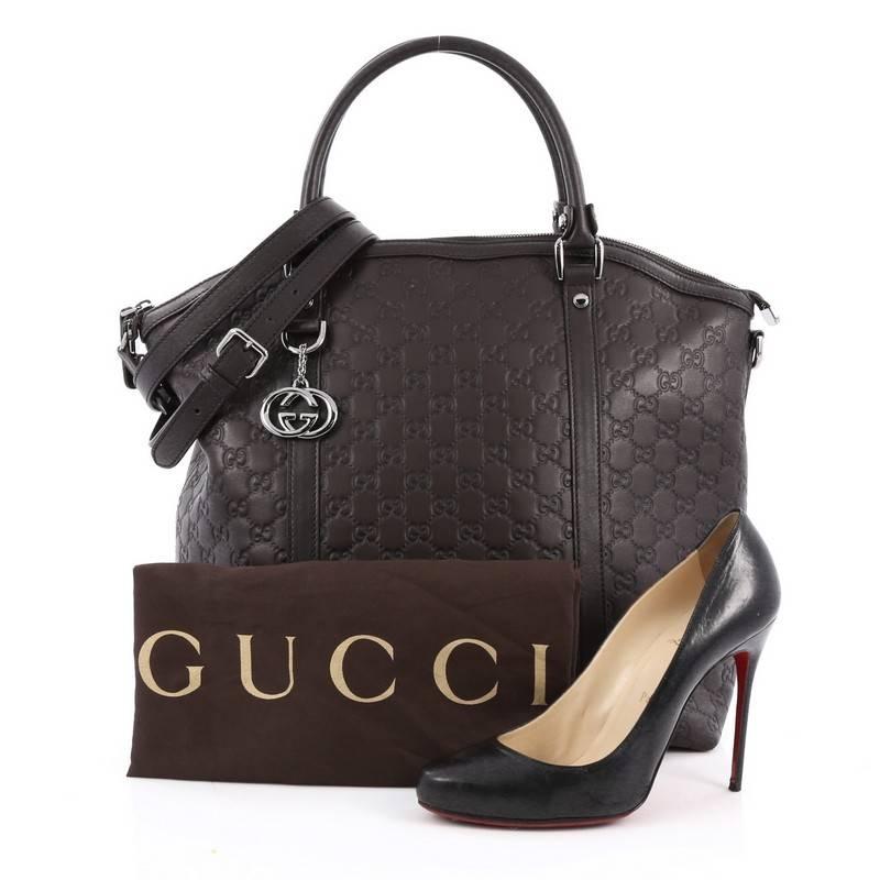 This authentic Gucci GG Charm Convertible Dome Satchel Guccissima Leather Large is a sophisticated bag perfect for your daily necessities. Crafted from brown giccissima leather, this bag features dual rolled leather handles, brown leather trims and