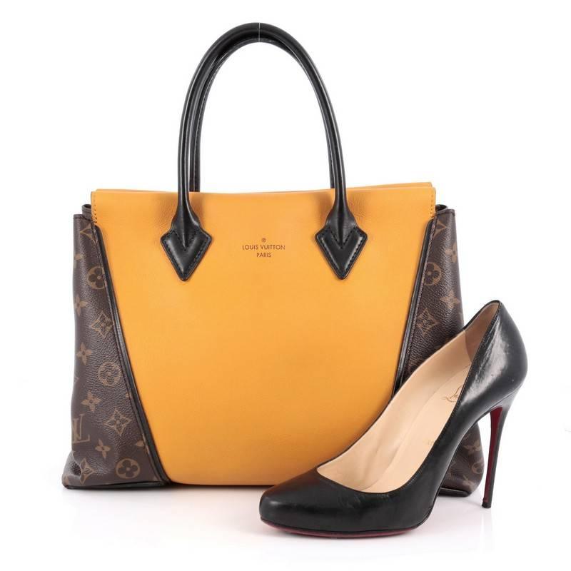 This authentic Louis Vuitton W Tote Monogram Canvas and Leather PM presented in the brand's 2013 Collection is a collector’s dream. Crafted in yellow leather and monogram coated canvas sides, this luxurious and elegant tote features dual-rolled