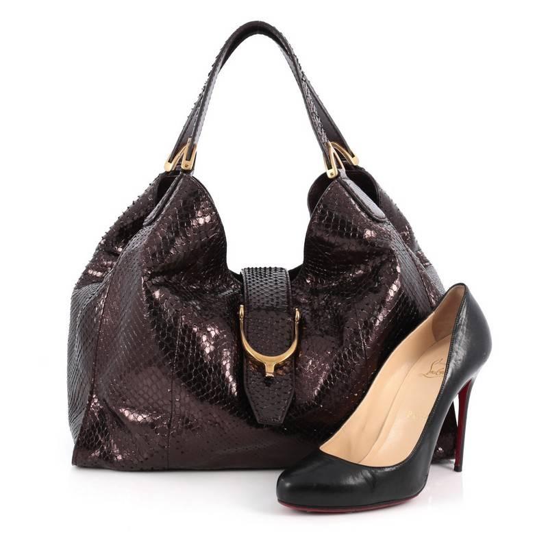 This authentic Gucci Soft Stirrup Tote Python Medium in luxurious and sleek design is made for all seasons. Crafted from genuine metallic purple python skin, this exotic hobo-style shoulder bag features side to side looped dual-flat handles with