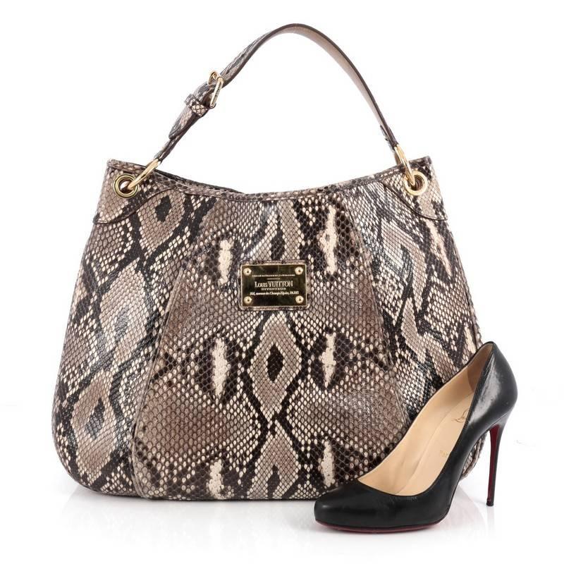 This authentic Louis Vuitton Galliera Handbag Smeralda Python GM presented during the brand's 2009 Cruise Collection is a limited piece made especially for Louis Vuitton lovers. Crafted from brown genuine smeralda python skin, this oversized,