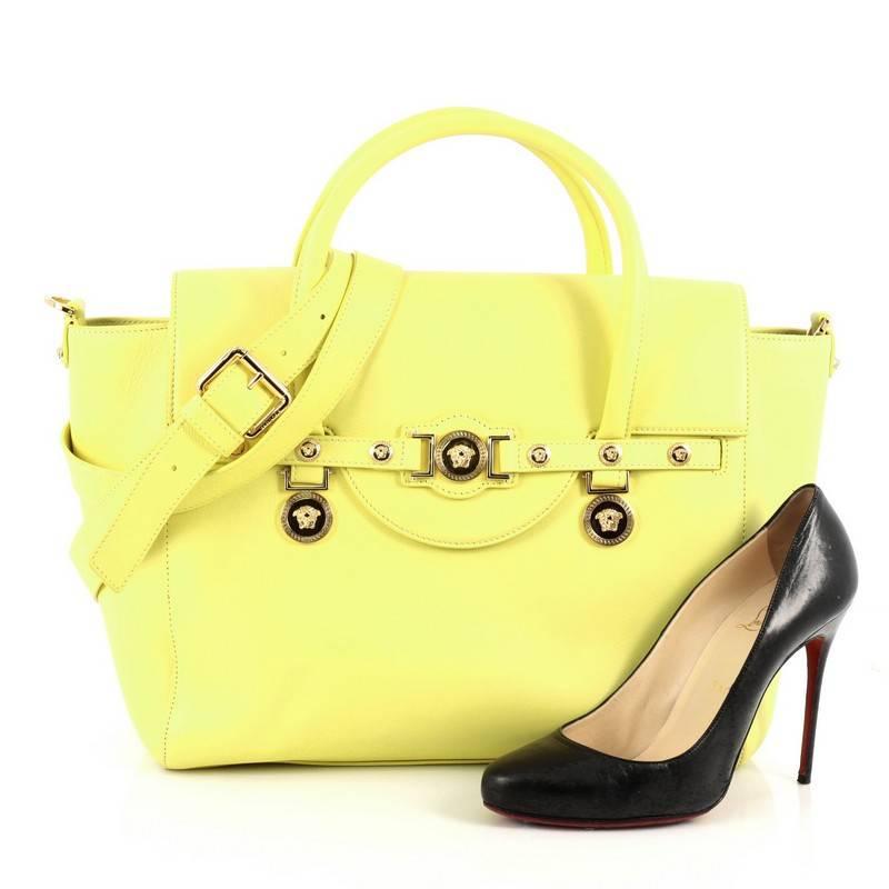 This authentic Versace Signature Bag Leather Large showcases an update to its classic Italian design with luxe detailing and a simple silhouette. Crafted in yellow leather, this structured yet elegant tote features iconic gold large Medusa medallion