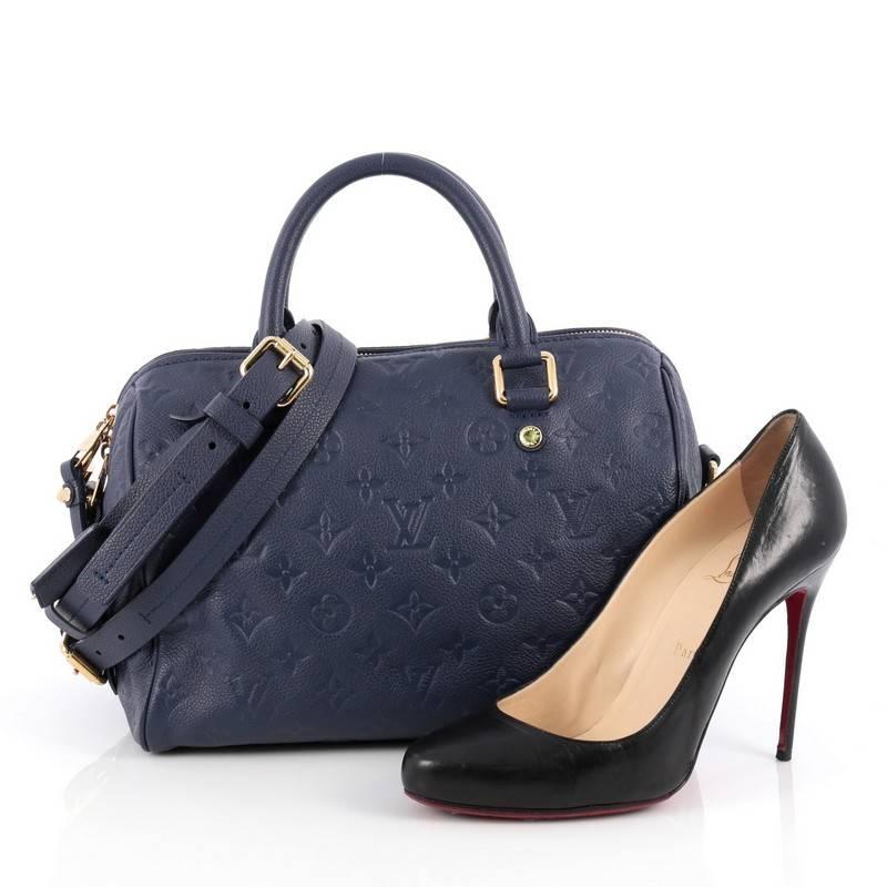 This authentic Louis Vuitton Speedy Bandouliere Bag Monogram Empreinte Leather 25 is a modern must-have. Constructed from Louis Vuitton's luxurious blue monogram empreinte leather, this iconic and re-imagined Speedy features dual-rolled leather