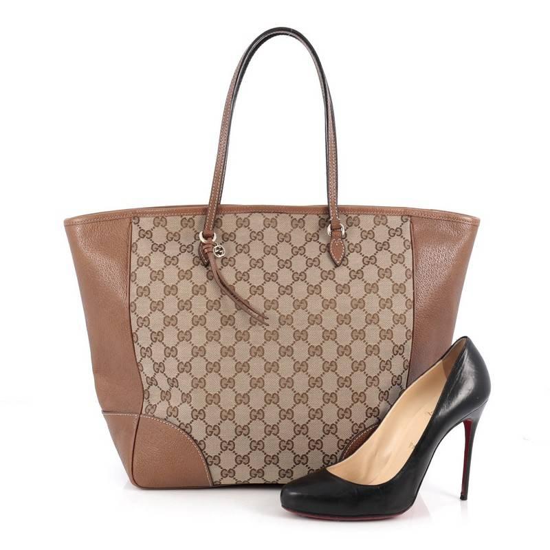 This authentic Gucci Bree Tote GG Canvas Medium is perfect for everyday casual looks. Crafted from brown GG canvas with brown leather trims, this simple shopper-style tote features dual tall handles, small Gucci charm, and gold-tone hardware