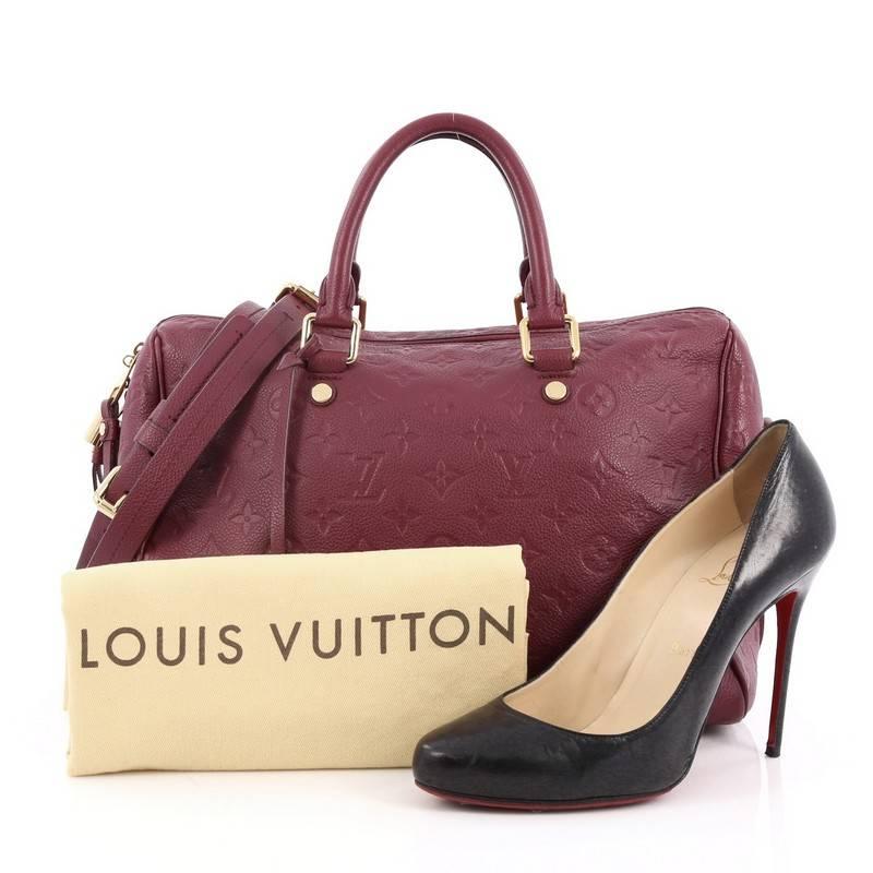 This authentic Louis Vuitton Speedy Bandouliere Bag Monogram Empreinte Leather 30 is a modern must-have. Constructed from Louis Vuitton's luxurious plum monogram embossed empreinte leather, this iconic and re-imagined Speedy features dual-rolled