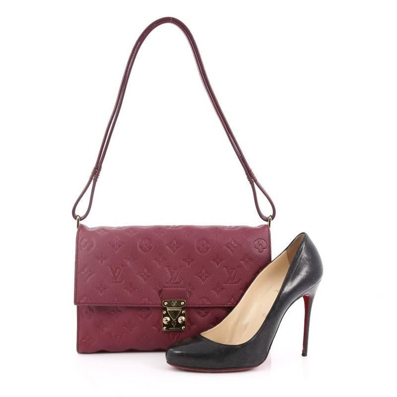 This authentic Louis Vuitton Fascinante Handbag Monogram Empreinte Leather mixes modern design with elegant versatility. Crafted from plum monogram empreinte leather, this versatile flap bag features an adjustable leather strap that allows it to be