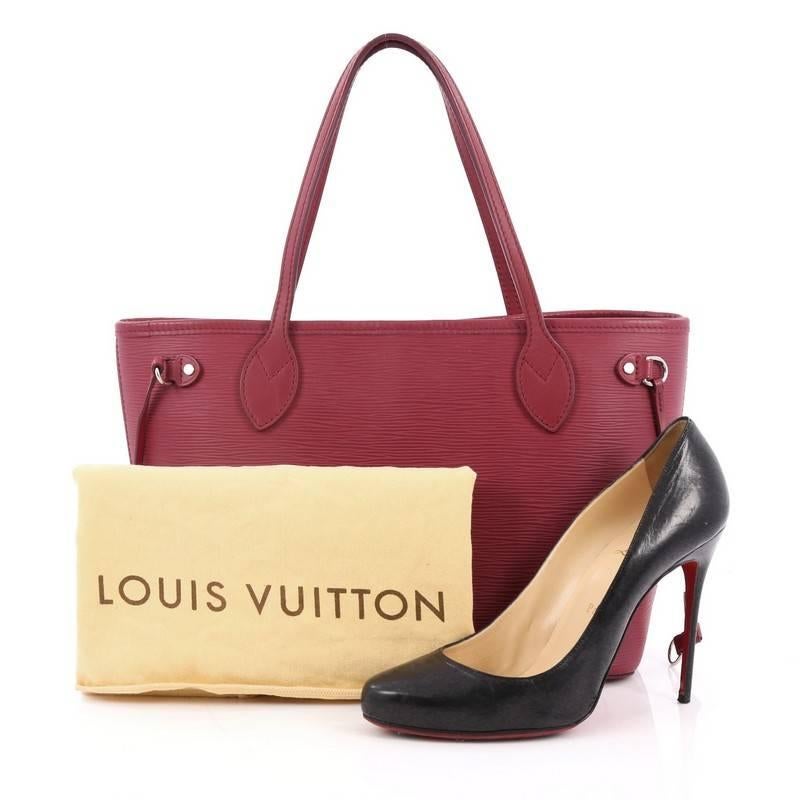 This authentic Louis Vuitton Neverfull Tote Epi Leather PM is a perfect companion for daily excursions. Crafted in magenta epi leather, this iconic, easy-to-carry tote features dual flat leather handles, side tassels that cinches and expands, and