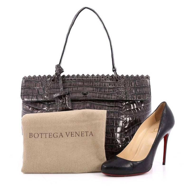 This authentic Bottega Veneta Tie-Dye Tiina Bag Crocodile Large is for the boldest of fashionistas, featured in Bottega Veneta's Fall 2010 Collection. Constructed with rich glossy grey genuine crocodile, the unique tie-dye is treated by hand