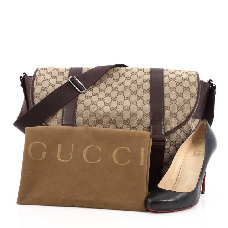 This authentic Gucci Belted Messenger GG Canvas Large is a classic for Gucci lovers. Crafted from brown GG canvas, this chic messenger bag features dark brown leather trims, adjustable shoulder strap, and gunmetal-tone hardware accents. Its belt and