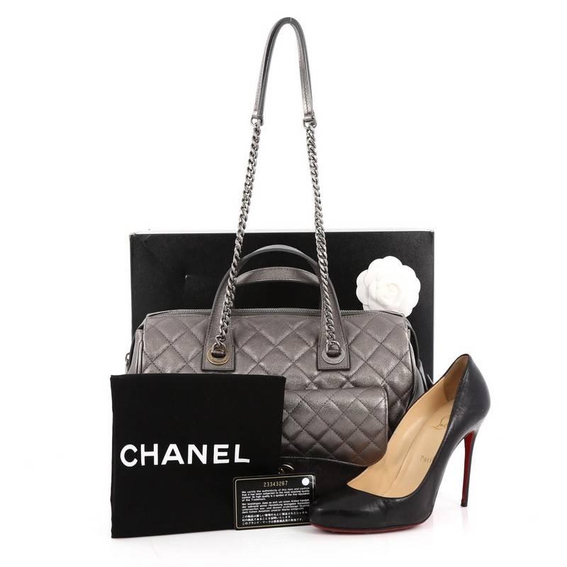This authentic Chanel Two-Tone Front Pocket Bowling Bag Quilted Metallic Calfskin Medium is ideal for everyday use. Crafted in dark silver quilted metallic calfskin leather, this bowling bag features dual leather top handles, chunky chain link