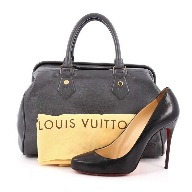 This authentic Louis Vuitton Cuir Cinema Intrigue Bag Leather is a gorgeous handle bag inspired by the iconic frame top doctor's bag. Crafted from dark grey leather, this chic bag features dual-rolled leather handles, discreet leather covered LV