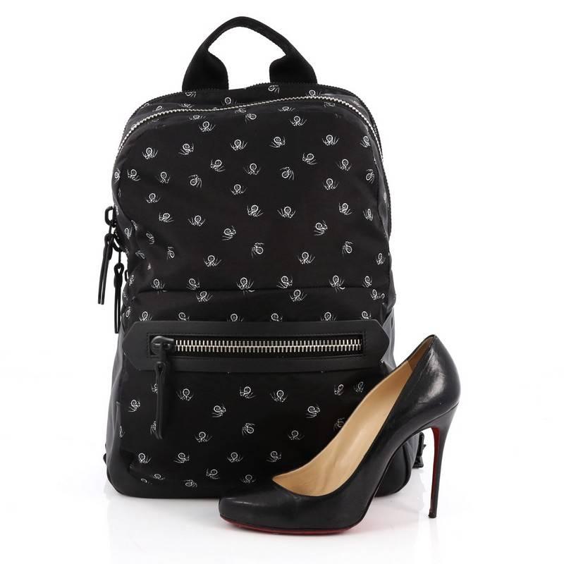 
This authentic Lanvin Backpack Printed Nylon with Leather balances a luxurious, playful style made for on-the-go fashionistas. Crafted from black nylon with printed small white spiders, this stylish backpack features adjustable leather traps, black