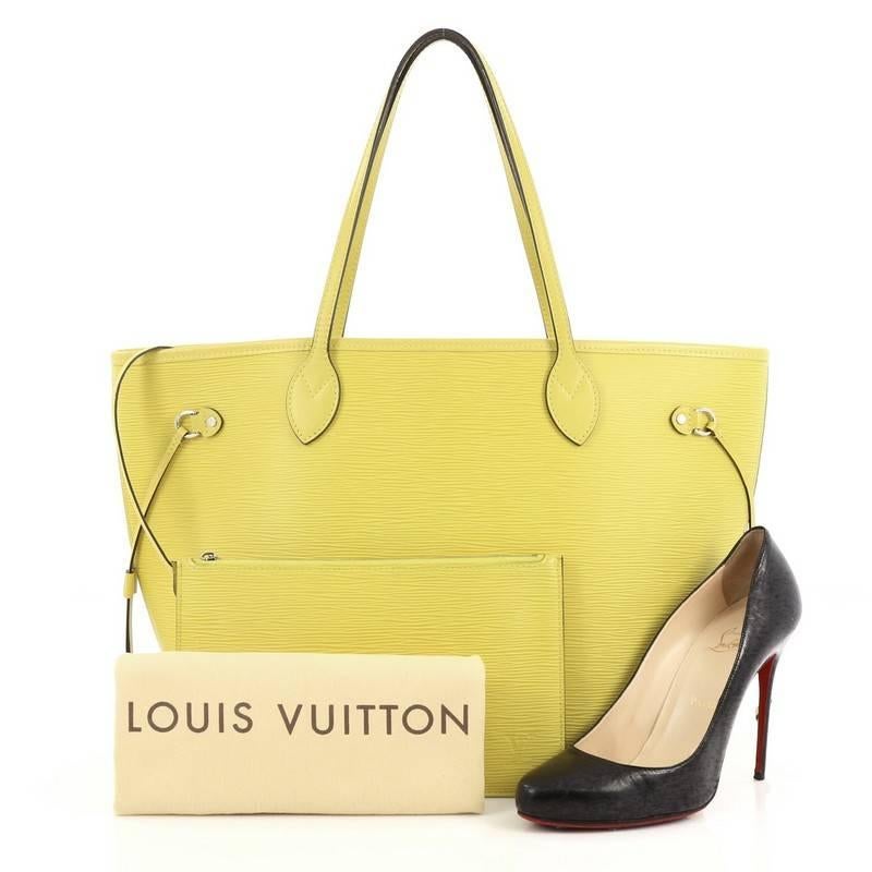 This authentic Louis Vuitton Neverfull Tote Epi Leather MM is a perfect companion for daily excursions. Crafted in yellow epi leather, this iconic, easy-to-carry tote features dual flat leather handles, side tassels that cinches and expands and