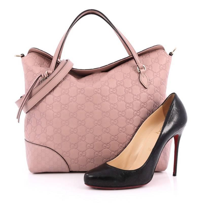 This authentic Gucci Bree Convertible Top Handle Bag Guccissima Leather Medium is an elegant bag perfect for everyday casual looks. Crafted in mauve guccissima leather, this no-fuss, slouchy tote features dual flat handles, leather string with