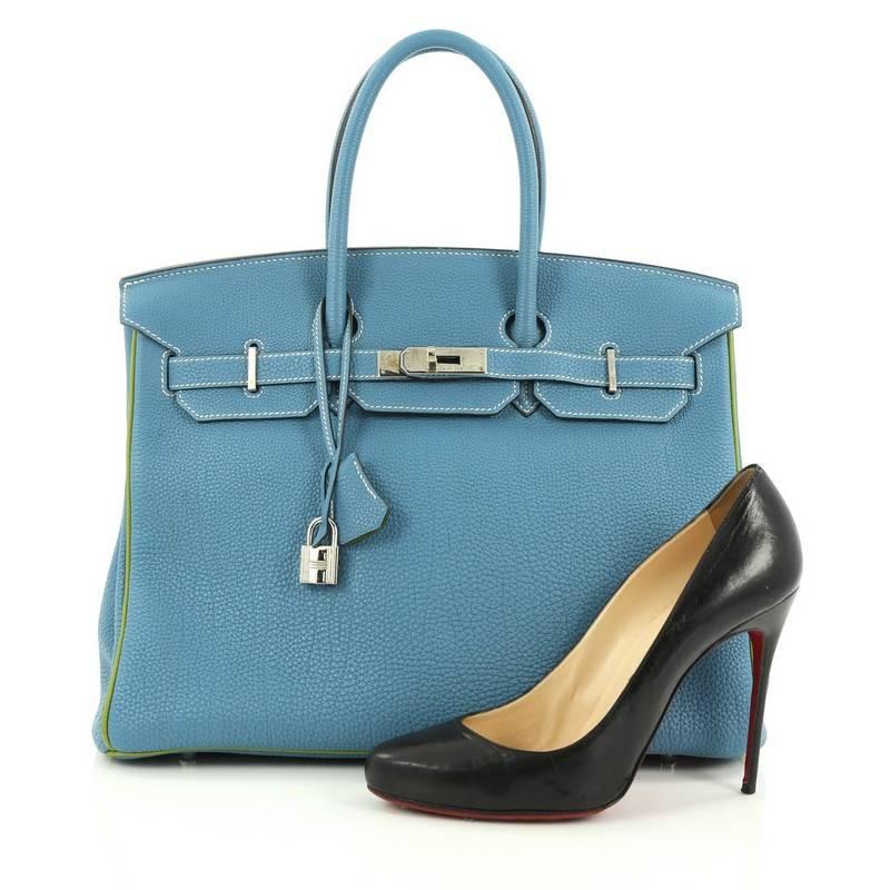 This authentic Hermes Birkin Handbag Blue Jean and Vert Anis Togo with Palladium Hardware 35 stands as one of the most-coveted and timeless bags fit for any fashionista. Uniquely constructed from scratch-resistant blue togo leather with green