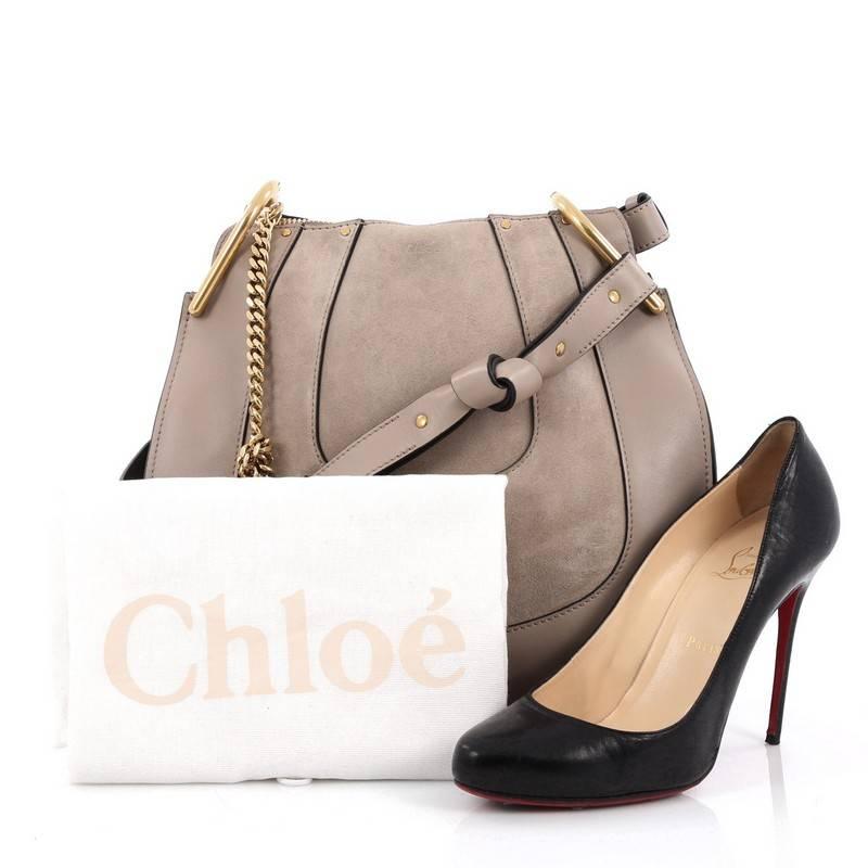 This authentic Chloe Hayley Hobo Leather and Suede Small mixes casual-bohemian styling with luxurious edge made for the Chloe girl. Crafted from taupe leather and suede, this hobo bag features adjustable shoulder strap, chain insets, saddle-shaped