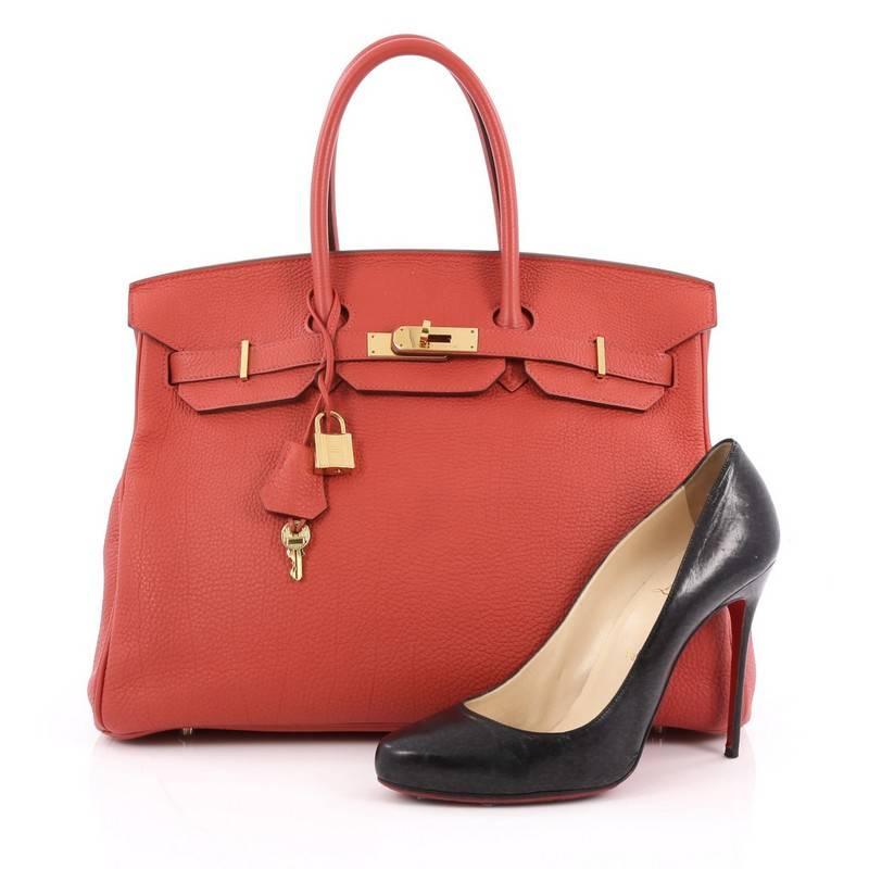 This authentic Hermes Birkin Handbag Geranium Togo with Gold Hardware 35 stands as one of the most-coveted bags. Crafted from scratch-resistant, iconic geranium red togo leather, this stand-out tote features dual-rolled top handles, frontal flap,