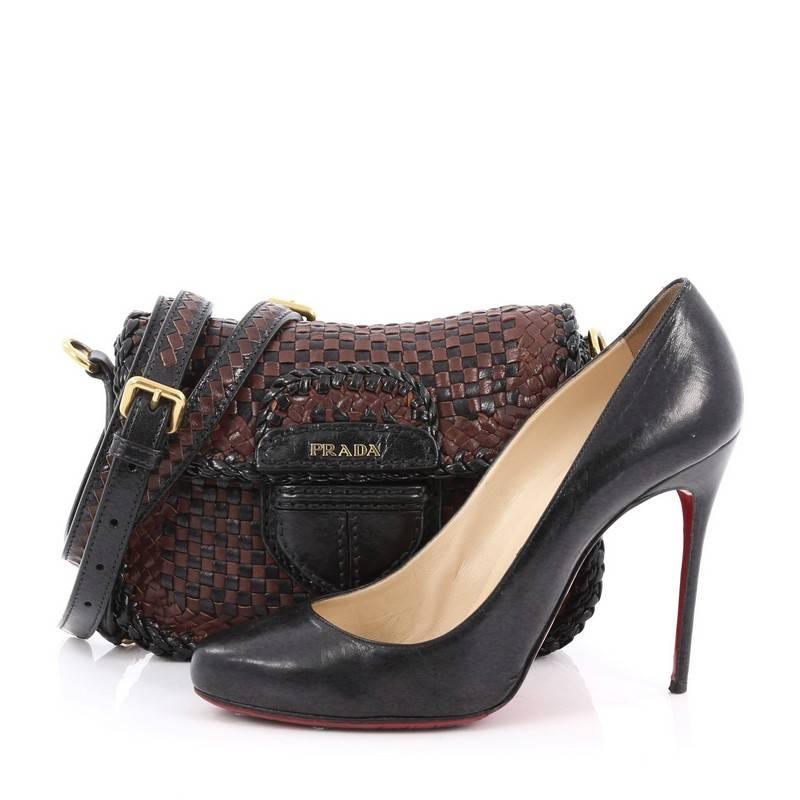 This authentic Prada Push Lock Flap Shoulder Bag Madras Woven Leather Small presents an industrial, heritage-inspired design perfect for modern chic fashionistas. Crafted in brown and black woven leather, this sturdy flap bag features leather