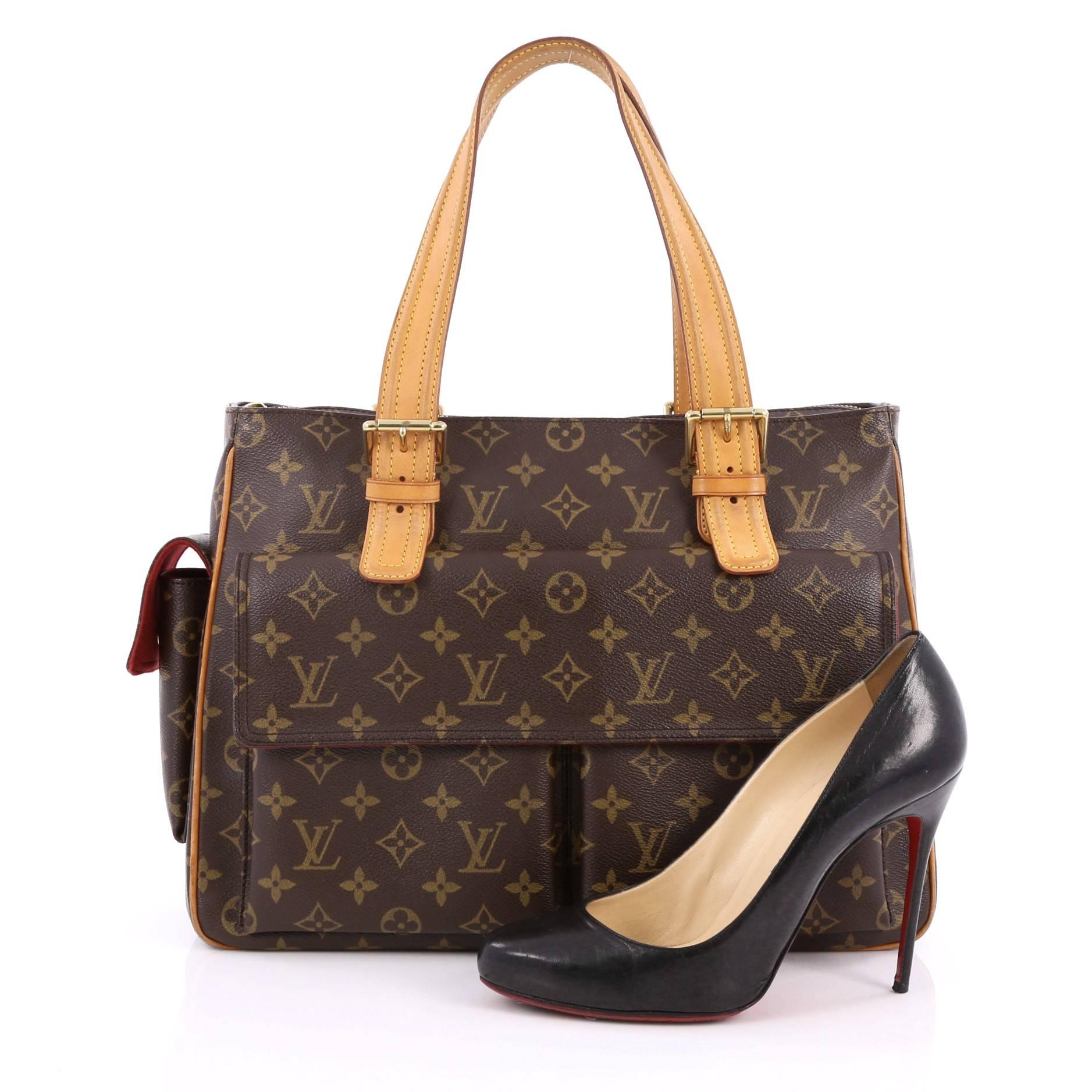 This authentic Louis Vuitton Multipli Cite Handbag Monogram Canvas showcases a simple design made for everyday use. Crafted from Louis Vuitton's iconic brown monogram coated canvas, this tote features dual adjustable vachetta leather straps,
