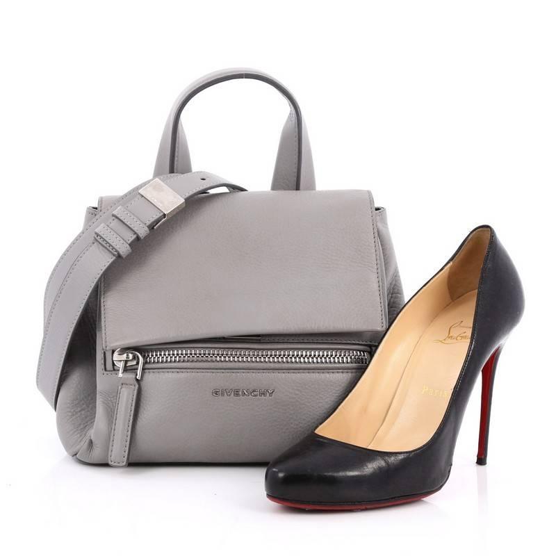 This authentic Givenchy Pandora Pure Satchel Leather Mini is an updated version of the Pandora first seen in Pre-Fall 2014 Collection adding versatility to the popular bag. Crafted in grey leather, this combined stylish flap and satchel bag features