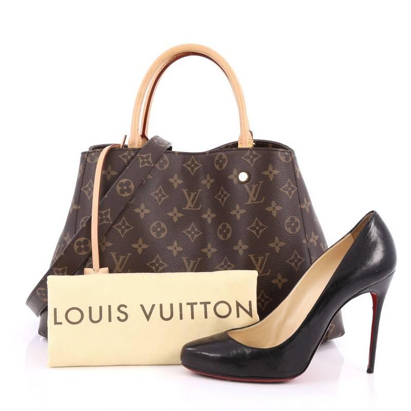 This authentic Louis Vuitton Montaigne Handbag Monogram Canvas MM named after the famed Parisian location is as sophisticated as it is sturdy. Crafted from the iconic Louis Vuitton's brown monogram coated canvas, this tote features dual-rolled