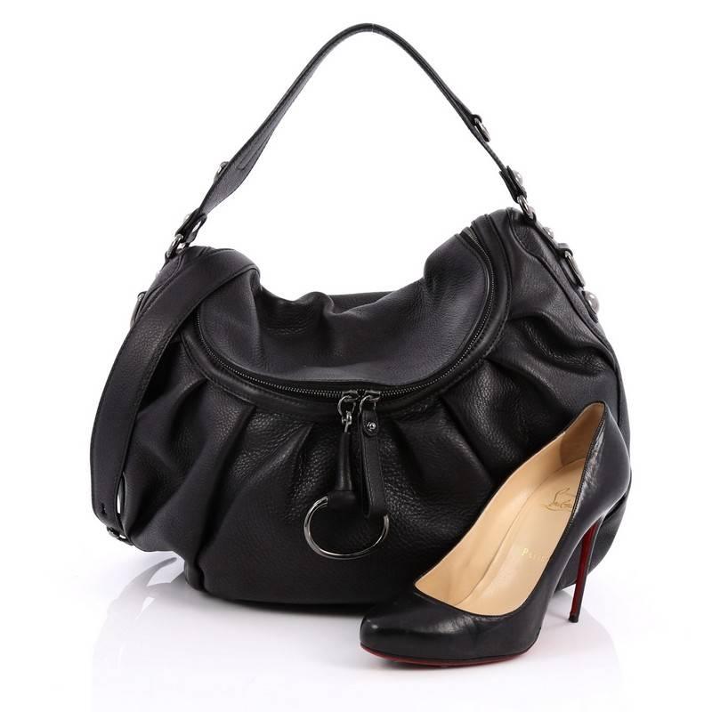 This authentic Gucci Icon Bit Convertible Hobo Leather Medium is a gorgeous bag that is all about the details. Crafted from black leather, this supple and durable bag features flat leather handles, long detachable leather shoulder strap, stunning