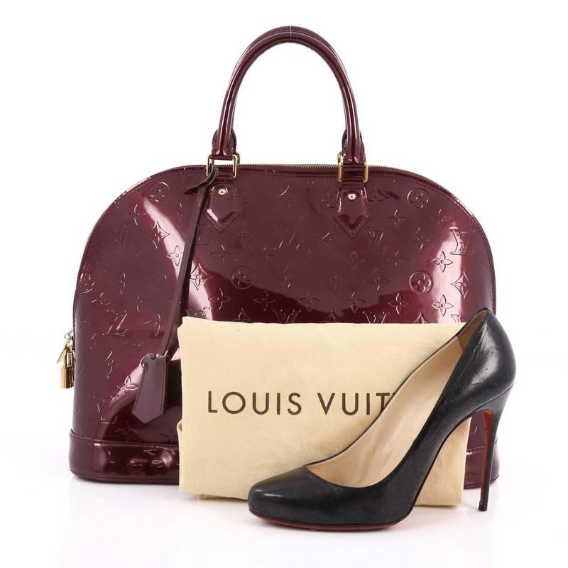This authentic Louis Vuitton Alma Handbag Monogram Vernis GM is a fresh and elegant spin on a classic style that is perfect for all seasons. Crafted from Louis Vuitton's violette monogram vernis, this dome-shaped satchel features double rolled