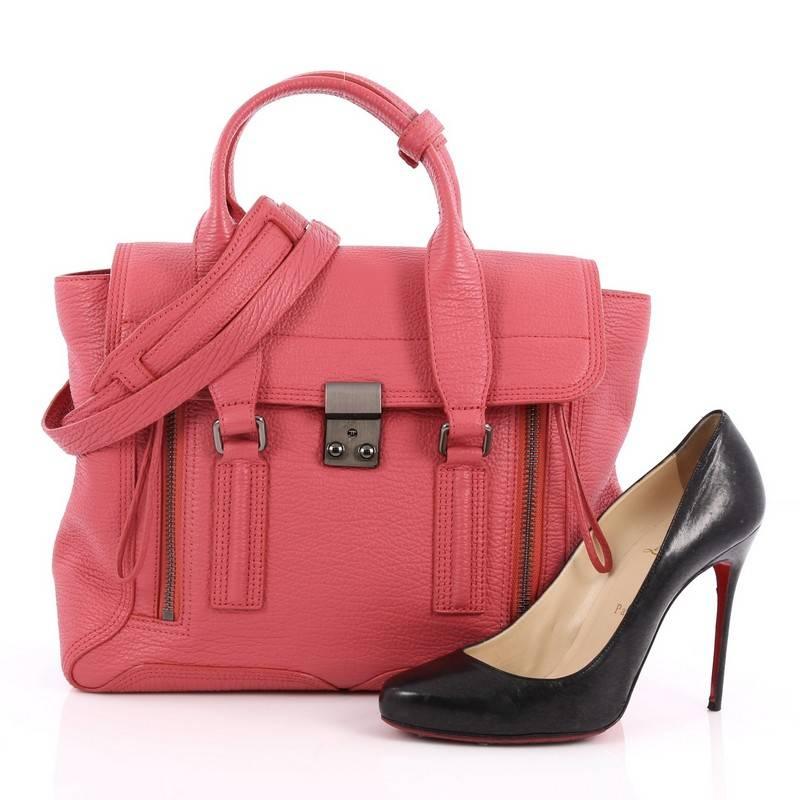 This authentic 3.1 Phillip Lim Pashli Satchel Leather Medium is a practical bag with a stylish edge made for on-the-go moments. Crafted from pink leather, this chic satchel features dual top handles, expandable zip sides, top flap push-lock closure