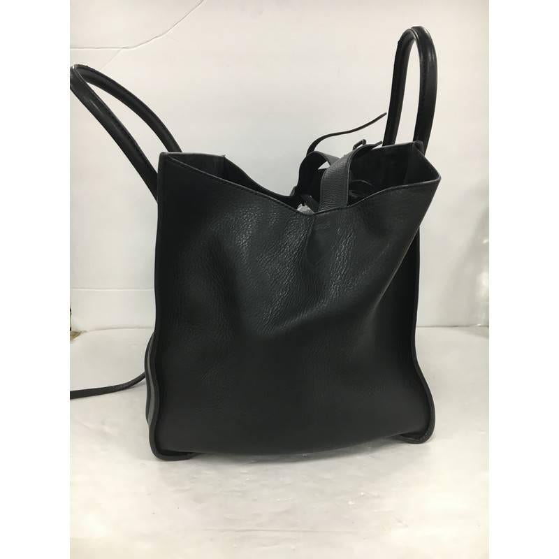 This authentic Celine Phantom Handbag Grainy Leather Medium is one of the most sought-after bags beloved by fashionistas. Crafted from black grainy leather, this minimalist tote features dual-rolled handles, an exterior front pocket, protective base