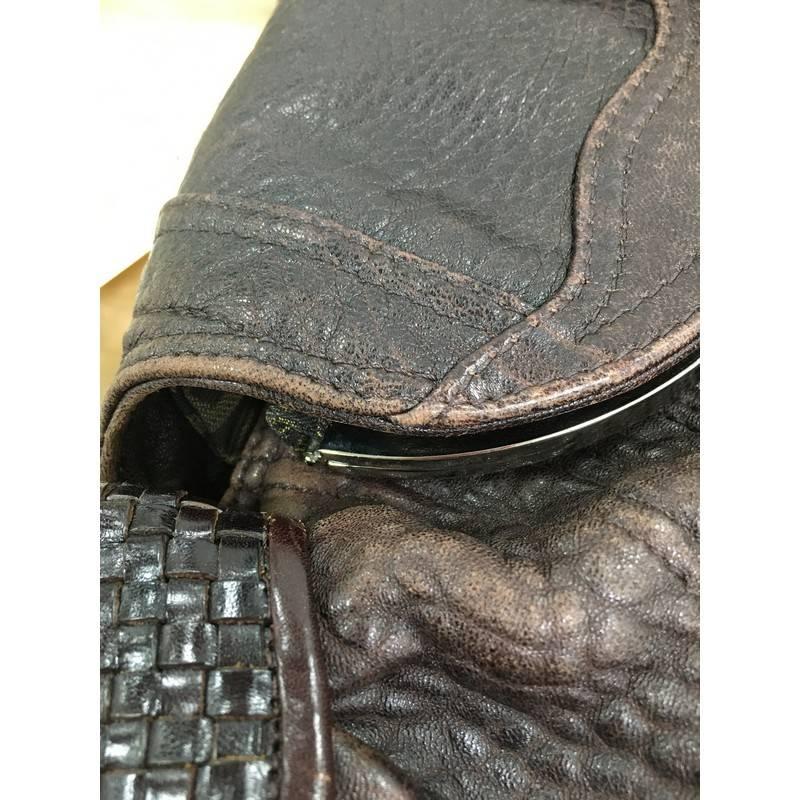 This authentic Fendi Spy Bag Leather showcases one of the brand's most popular designs. Crafted in brown leather, this alluring bag features dual spiked woven leather handles, pleated silhouette, hidden pocket at its flap, a secret compartment near