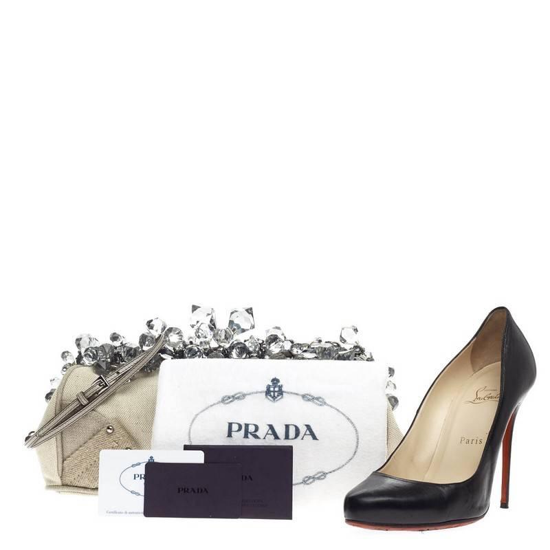 This authentic Prada Crystal Frame Convertible Clutch Canvas Medium is truly a stylish clutch, perfect for day or evening. Crafted from naturale mistolino canvas fabric, this stunning clutch features detachable shoulder strap, resin crystal clusters