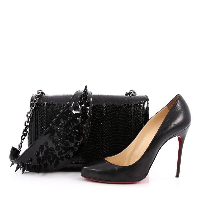 This authentic Christian Louboutin Artemis Shoulder Bag Spiked Snakeskin Small is a dramatic shoulder piece perfect for the bold and stylish fashionista. Crafted from genuine black snakeskin with patent leather trims, this bag features, chain-link