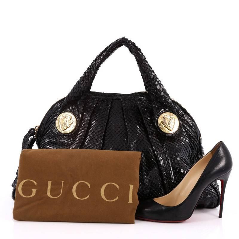This authentic Gucci Hysteria Dome Satchel Snakeskin Large is a lovely accessory for any Gucci lover showcasing an easy-casual yet elegant design. Crafted from genuine black snakeskin, this luxurious bag showcases dual shoulder straps with gold-tone